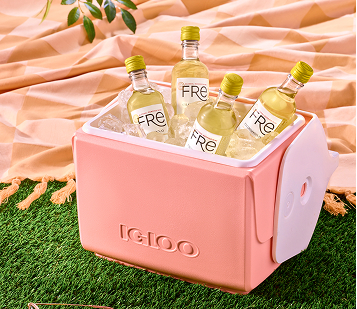 A pink Igloo cooler is filled with ice and mini 187ml bottles of Fre non-alcoholic Chardonnay white wine