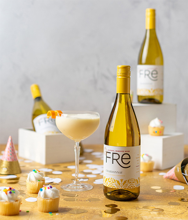 Three bottles of FRE Alcohol-Removed Chardonnay and a orange mocktail