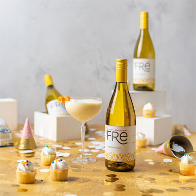 Three bottles of FRE Alcohol-Removed Chardonnay and a orange mocktail