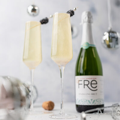 color image of FRE Alcohol-Removed Sparkling Brut with two champagne glasses on a white background